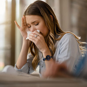 woman blowing her nose
