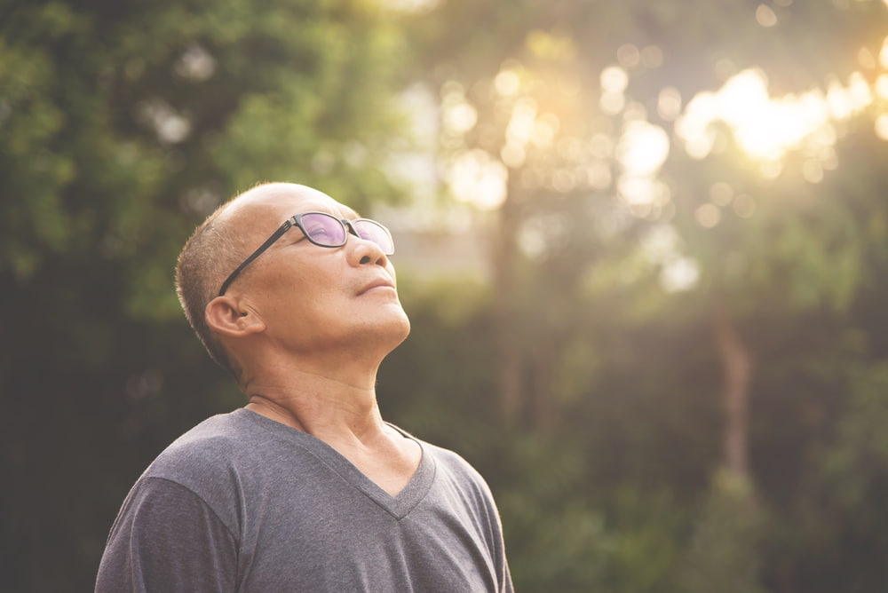 man smelling the air outside