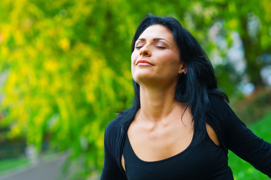 woman with sinus relief outdoors